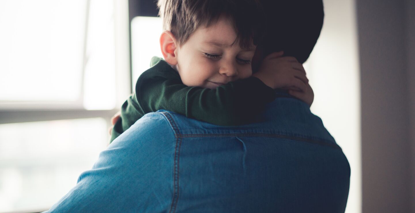 A little boy hugging his dad