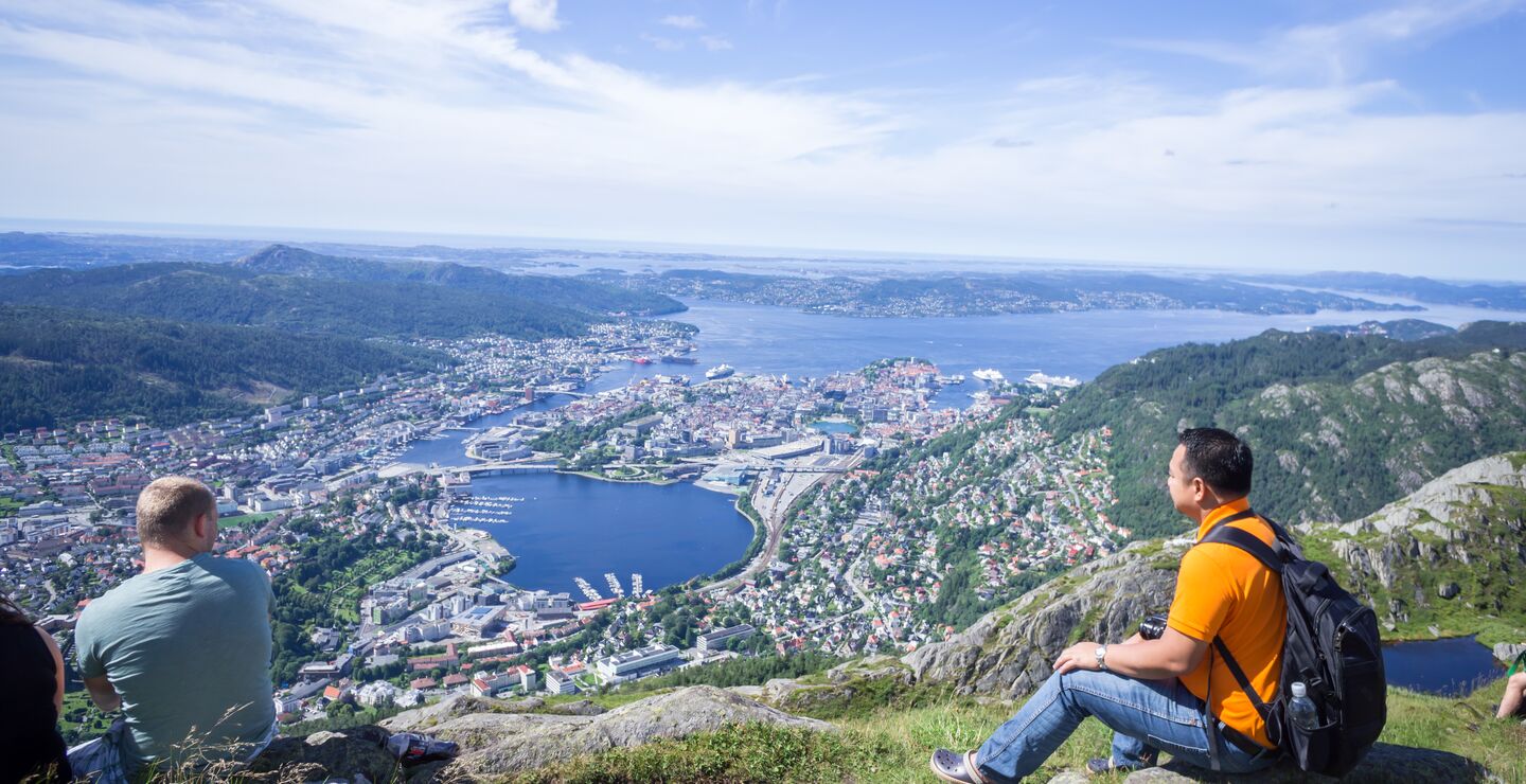 People watching the view of Bergen on top of a mountain 