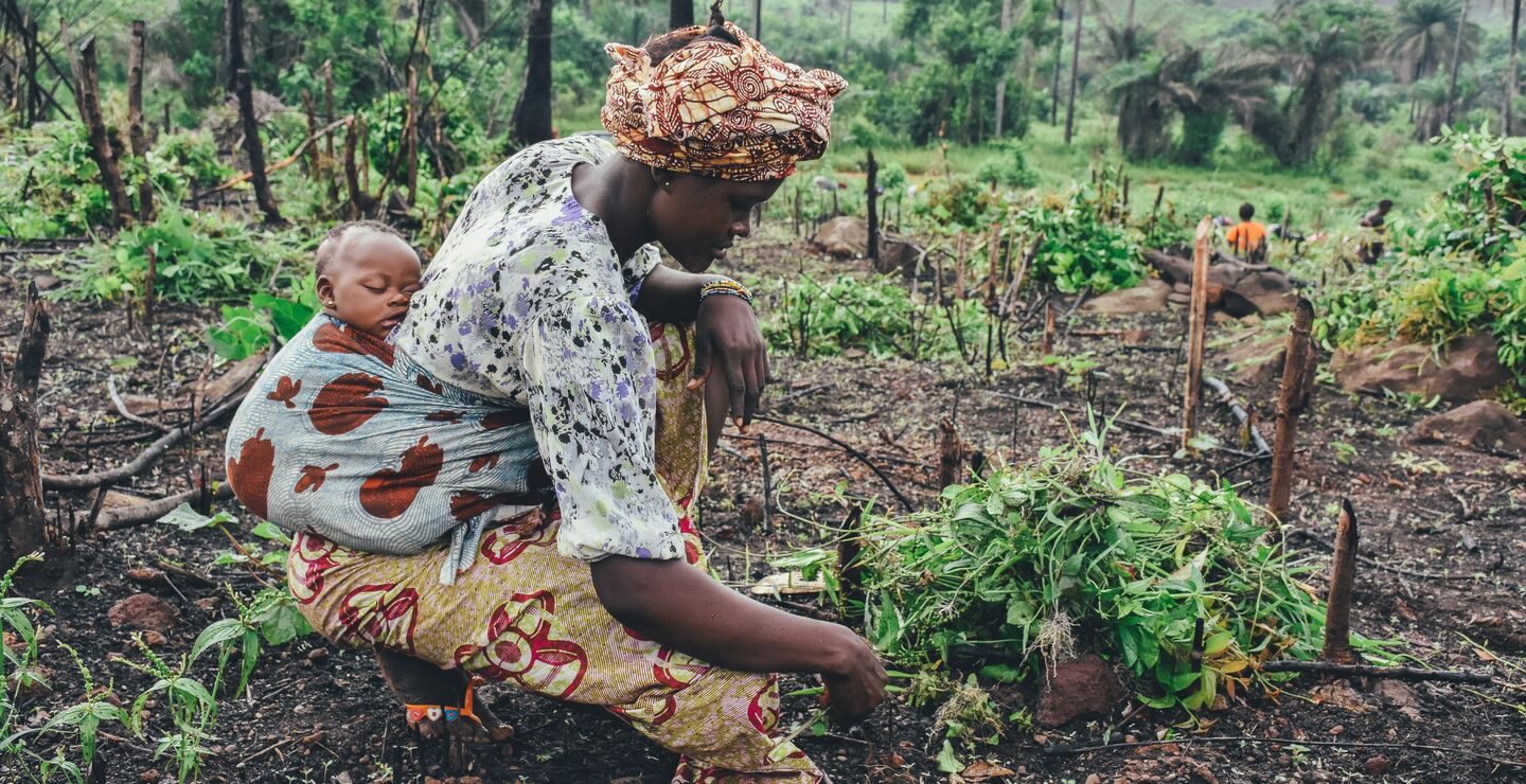 woman carrying baby on back